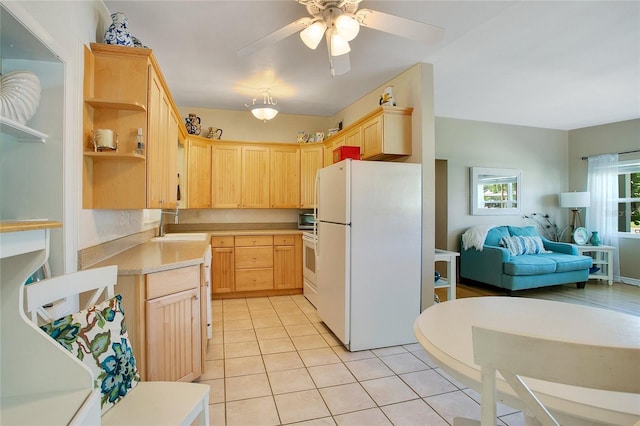 kitchen with light brown cabinets, ceiling fan, light tile patterned flooring, sink, and white appliances