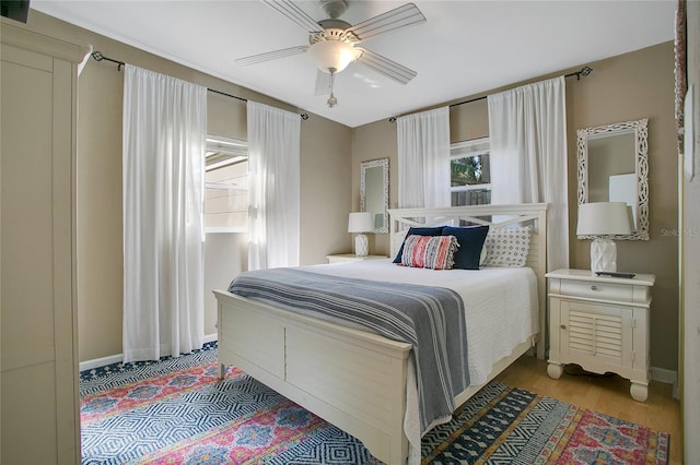 bedroom with light hardwood / wood-style floors and ceiling fan