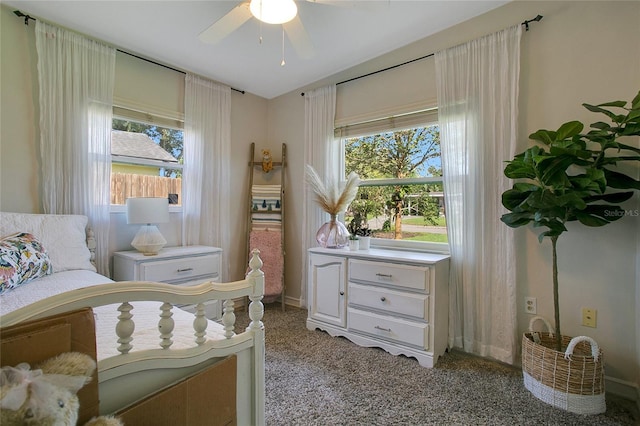 bedroom with ceiling fan, multiple windows, and light colored carpet