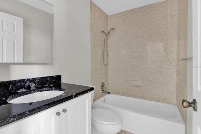 full bathroom with vanity, toilet, and tiled shower / bath