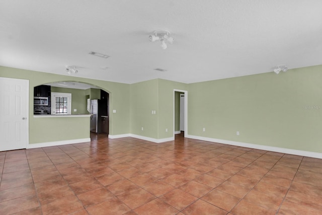 unfurnished room with tile patterned floors