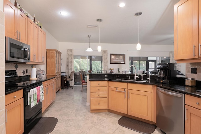 kitchen featuring stainless steel appliances, plenty of natural light, decorative light fixtures, and sink