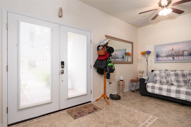 foyer entrance featuring light tile patterned flooring, ceiling fan, and french doors