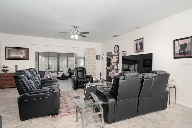 tiled living room with ceiling fan and a textured ceiling