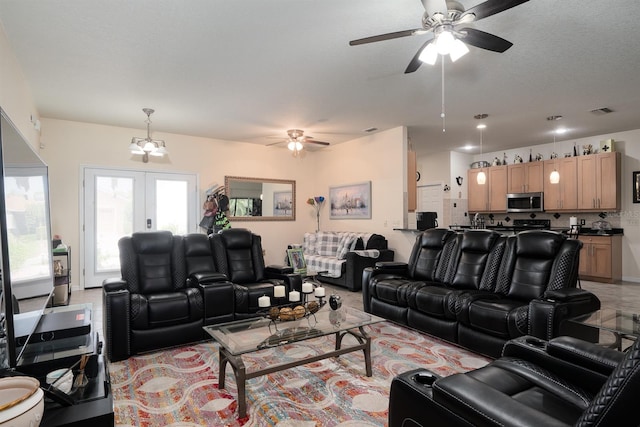 living room featuring ceiling fan and french doors