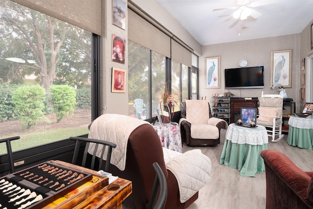 living room featuring plenty of natural light, ceiling fan, and hardwood / wood-style flooring