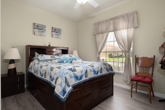 bedroom with ceiling fan and light hardwood / wood-style flooring