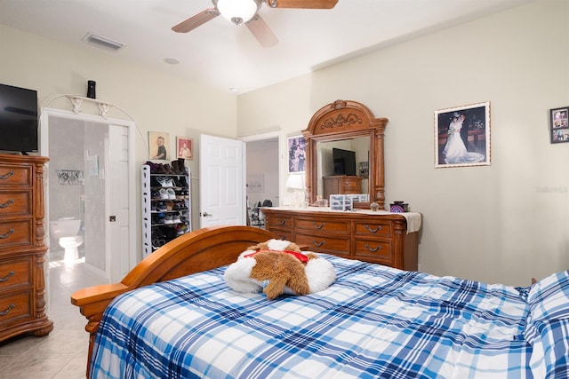 tiled bedroom featuring ensuite bath and ceiling fan