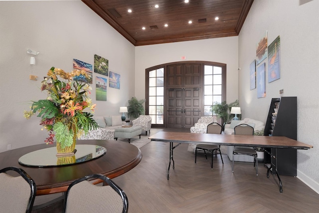 office area with wood ceiling, a towering ceiling, and parquet floors