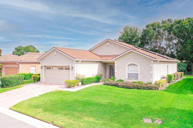 single story home with a front yard and a garage