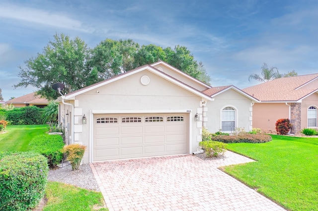 single story home with a garage and a front yard