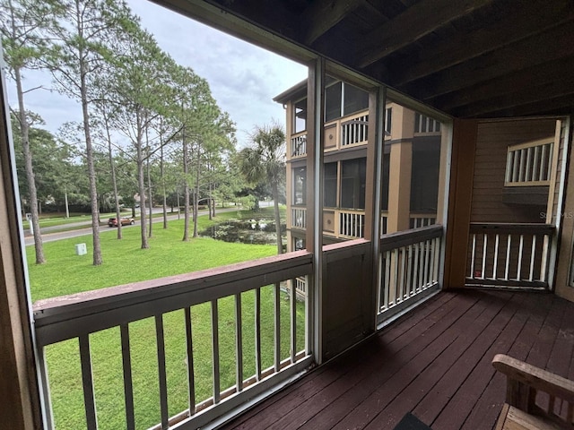 wooden terrace with a lawn