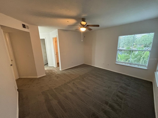 carpeted spare room featuring ceiling fan