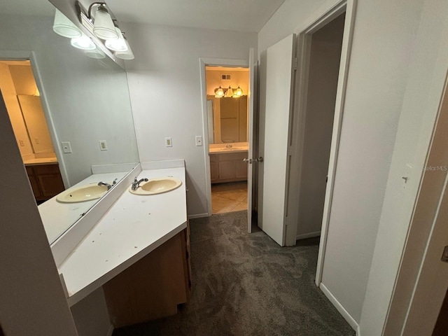470 S Pin Oak Pl Unit 204, Longwood, FL 32779 - bathroom featuring two vanities, visible vents, and a sink