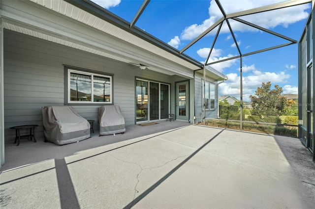 unfurnished sunroom featuring ceiling fan