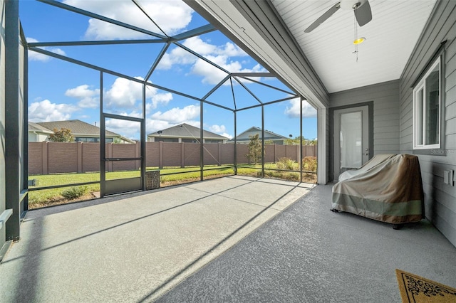 unfurnished sunroom featuring ceiling fan