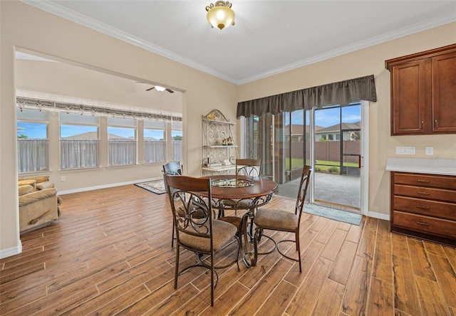 dining area featuring plenty of natural light, light hardwood / wood-style floors, and crown molding