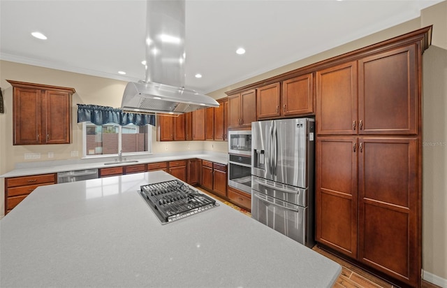 kitchen featuring light hardwood / wood-style floors, sink, island range hood, stainless steel appliances, and ornamental molding