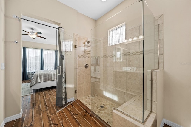 bathroom featuring ceiling fan and a shower with shower door