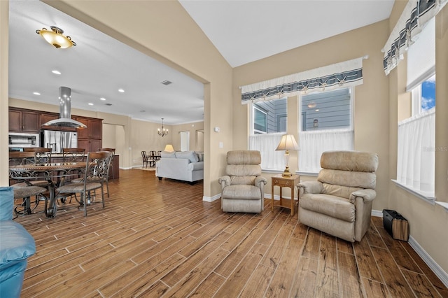 living room with hardwood / wood-style floors, a chandelier, and a healthy amount of sunlight