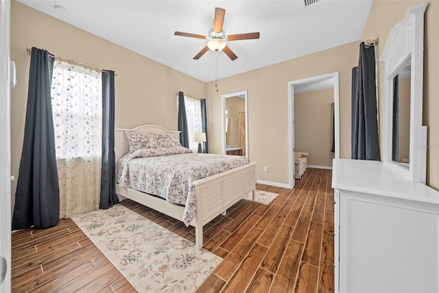 bedroom featuring ceiling fan, ensuite bathroom, and dark wood-type flooring