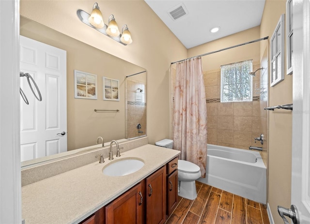 full bathroom with vanity, hardwood / wood-style flooring, shower / tub combo, and toilet