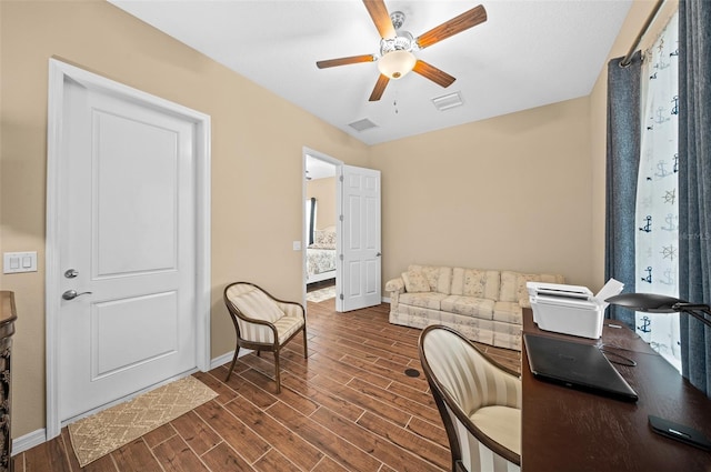 home office with ceiling fan and dark hardwood / wood-style flooring