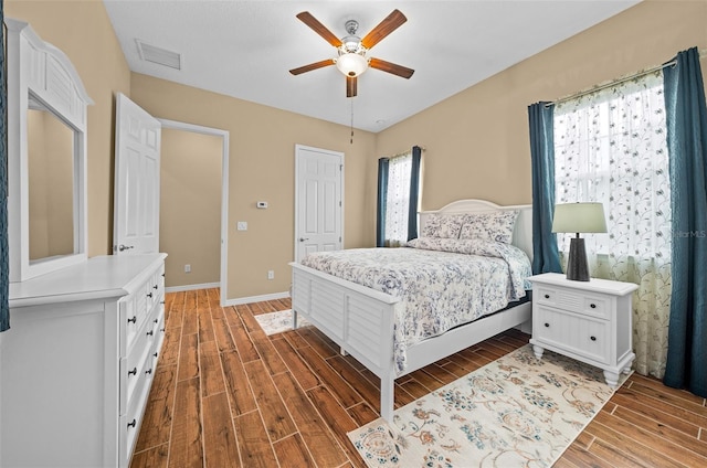 bedroom featuring ceiling fan and dark wood-type flooring