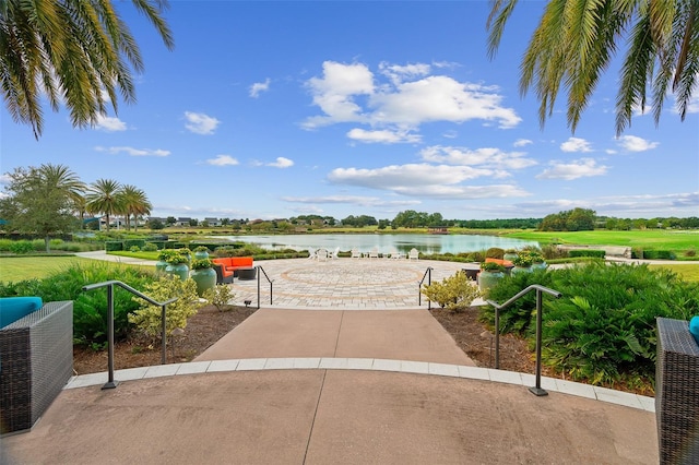 surrounding community with a patio and a water view