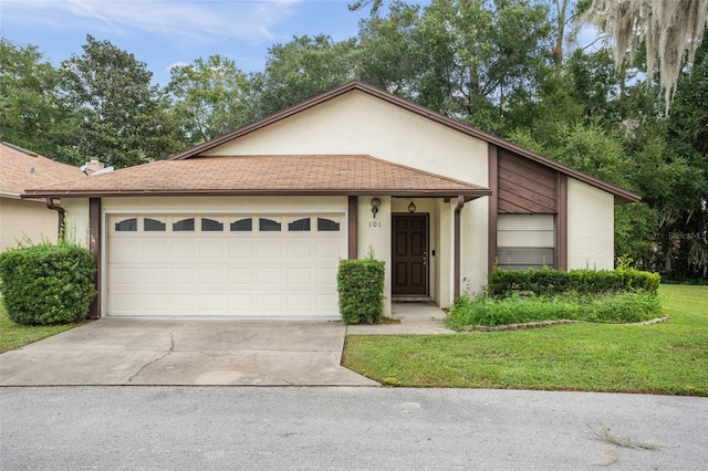 ranch-style house with a front yard and a garage