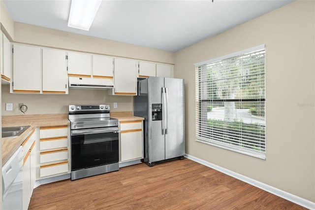 kitchen featuring light hardwood / wood-style floors, sink, stainless steel appliances, and white cabinets