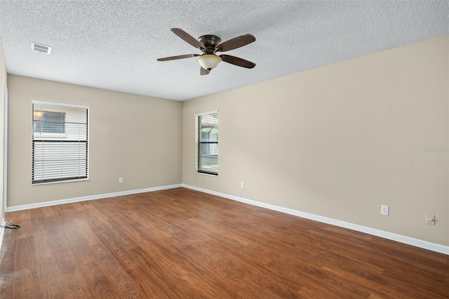 spare room featuring ceiling fan, hardwood / wood-style flooring, and a textured ceiling