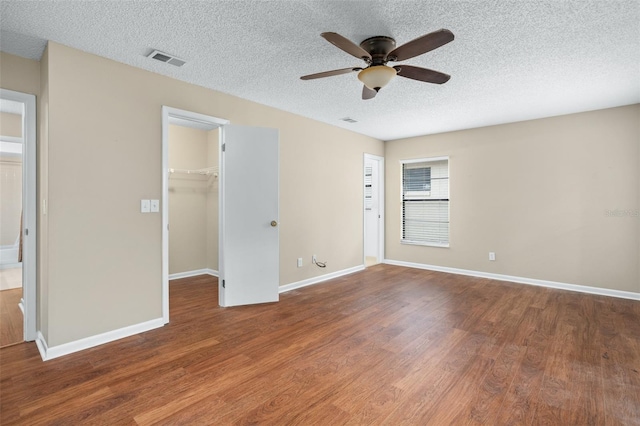 unfurnished room featuring a textured ceiling, ceiling fan, and hardwood / wood-style flooring