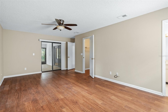 unfurnished room featuring ceiling fan, a textured ceiling, and light hardwood / wood-style flooring