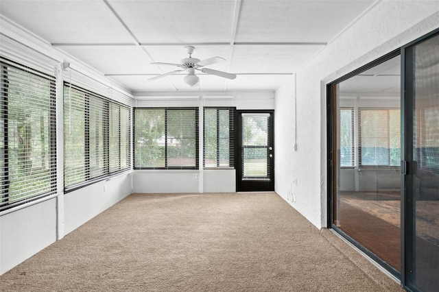 unfurnished sunroom with ceiling fan