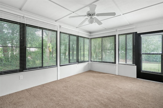 unfurnished sunroom featuring ceiling fan and plenty of natural light