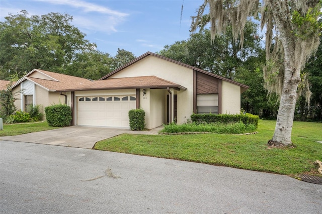 view of front of property with a garage and a front yard