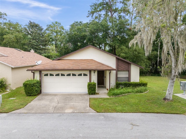 ranch-style home featuring a front lawn and a garage