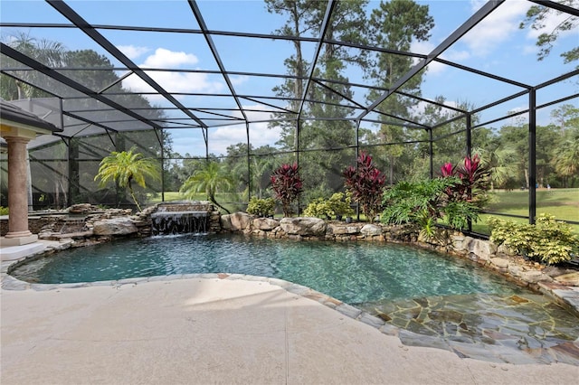 view of pool featuring pool water feature, a patio, and glass enclosure