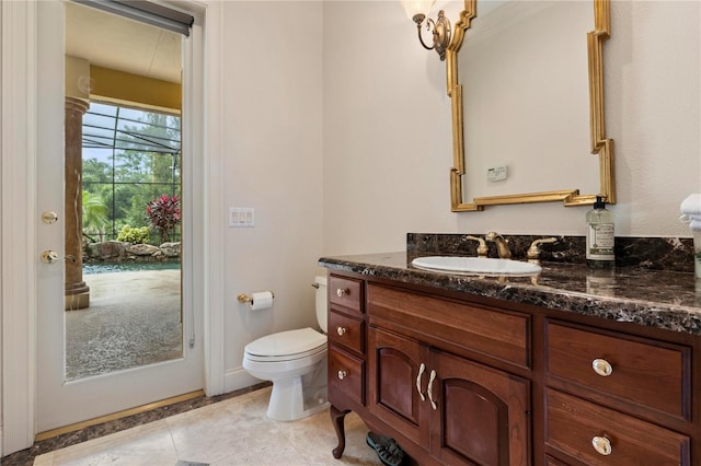 bathroom featuring tile patterned flooring, vanity, and toilet