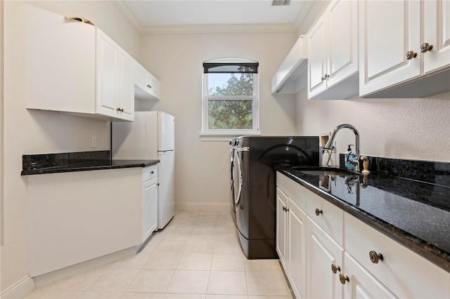 washroom with cabinets, sink, light tile patterned flooring, and crown molding