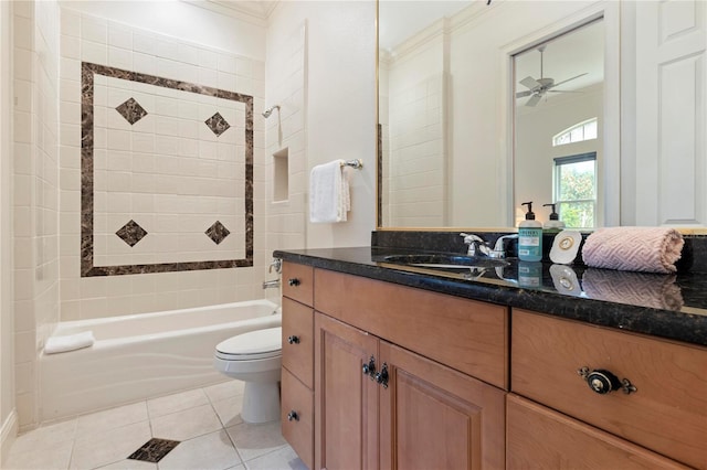 full bathroom featuring ceiling fan, vanity, tiled shower / bath combo, tile patterned floors, and toilet