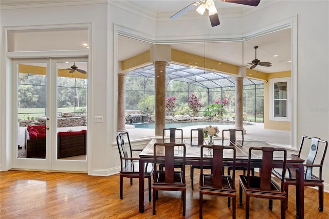 dining space featuring ornamental molding and hardwood / wood-style floors