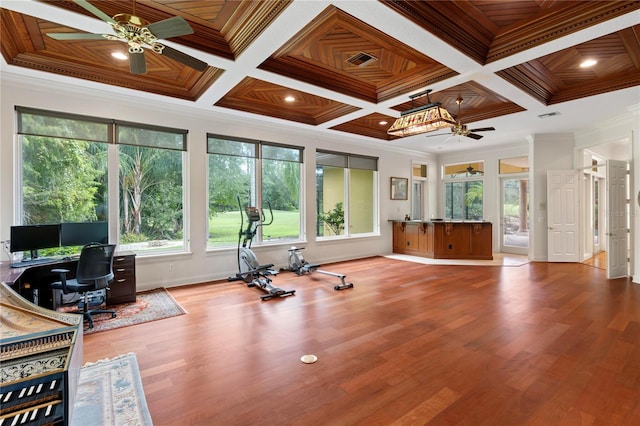 exercise room featuring light wood-type flooring, coffered ceiling, crown molding, ceiling fan, and wooden ceiling