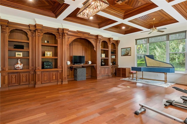 misc room with ceiling fan, coffered ceiling, hardwood / wood-style floors, and crown molding