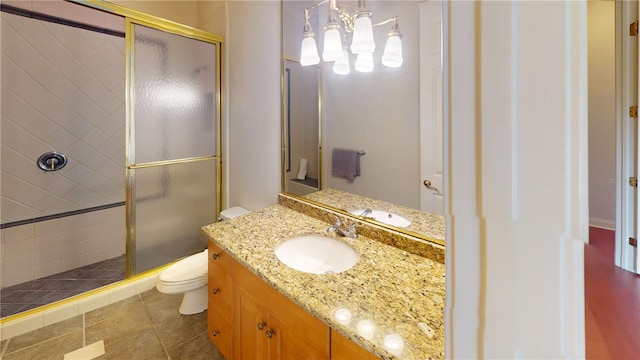 bathroom with walk in shower, vanity, toilet, and tile patterned floors