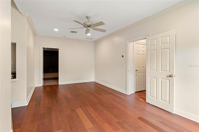 spare room featuring wood-type flooring, ceiling fan, and crown molding