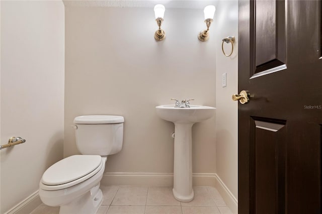 bathroom with tile patterned flooring and toilet