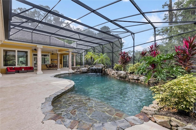 view of swimming pool featuring a lanai, a patio, ceiling fan, and pool water feature