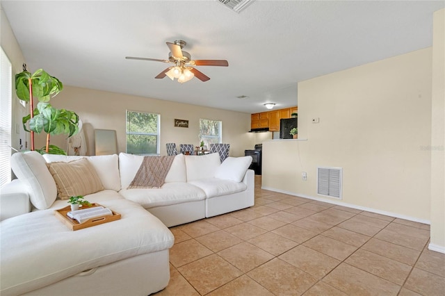 living room with light tile patterned floors and ceiling fan